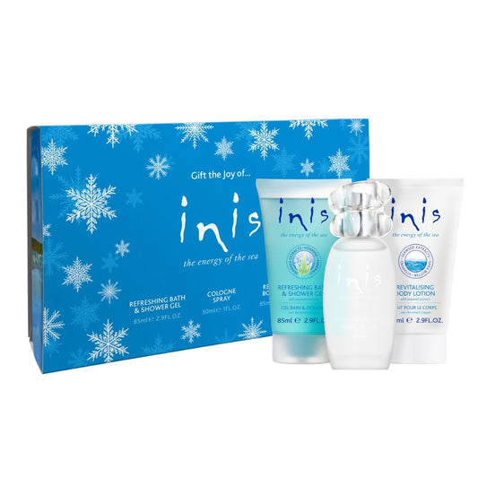 Inis Christmas gift set with cologne spray, body lotion, and shower gel beside a blue snowflake gift box